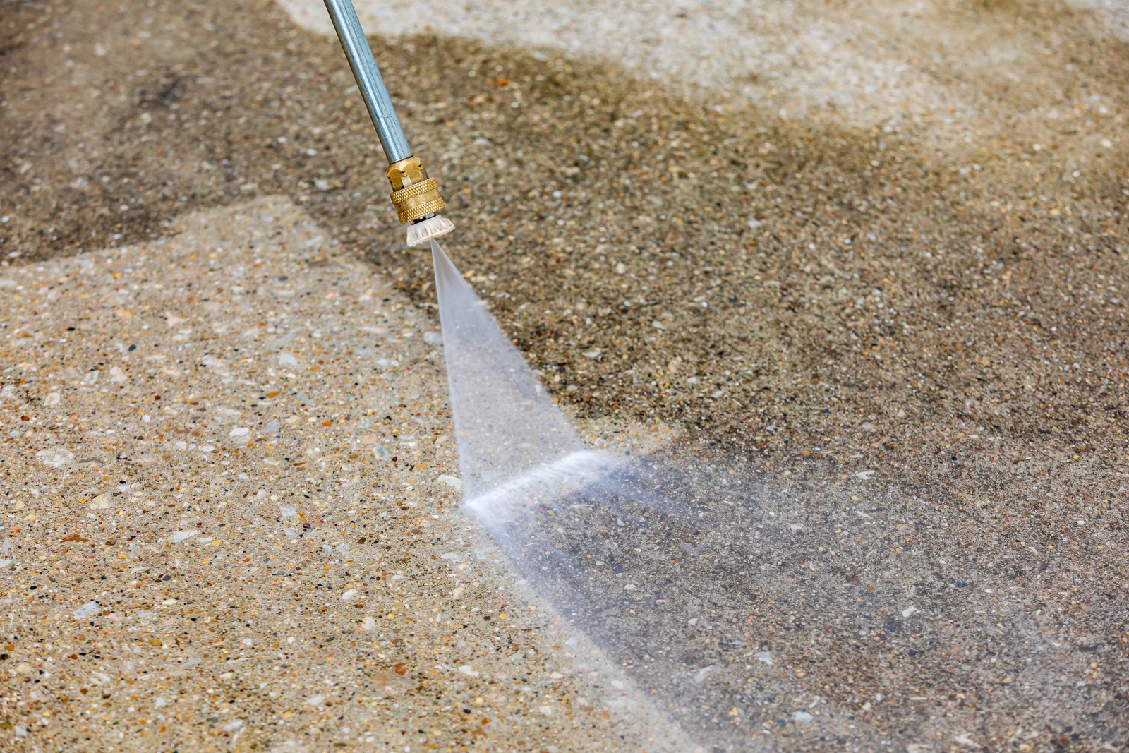 Close-up of driveway surface cleaning in progress