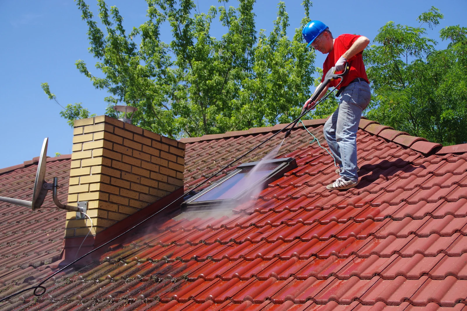 Soft wash treatment removing buildup from a tile roof